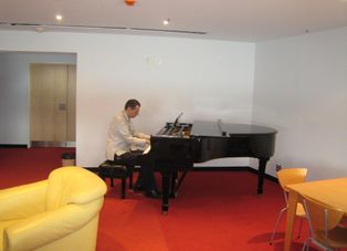 Our guide playing the piano in the dressing room Guided Backstage Tour of Sydney Opera House