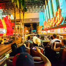 The Las Vegas Big Bus driving by Binion's Casino at the Fremont Street Experience during the optional night tour.