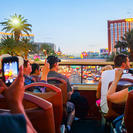 Tourists taking photos just after sunset on the Big Bus Las Vegas Hop-On Hop-Off tour.